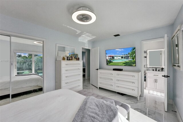 bedroom featuring ceiling fan and ensuite bathroom