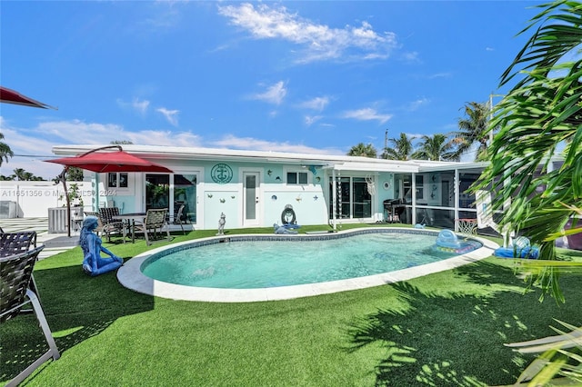 view of swimming pool featuring a grill, a lawn, and a patio