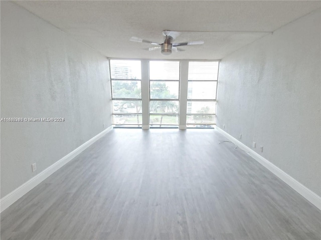 spare room featuring ceiling fan and hardwood / wood-style floors