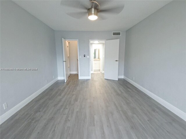 empty room featuring ceiling fan and wood-type flooring