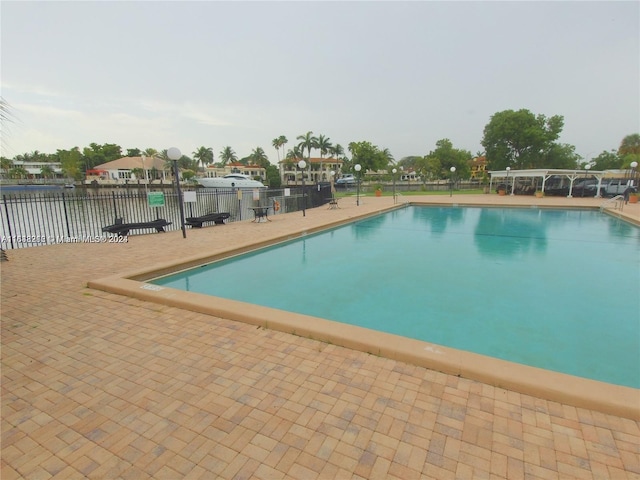 view of swimming pool with a water view