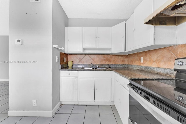 kitchen with white cabinets, electric range, decorative backsplash, and sink