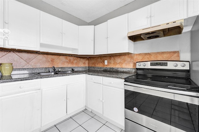 kitchen featuring sink, backsplash, white cabinetry, and stainless steel range with electric stovetop