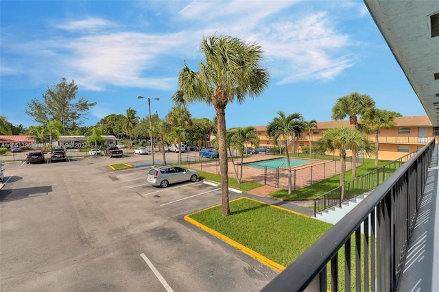 exterior space featuring a community pool and a yard