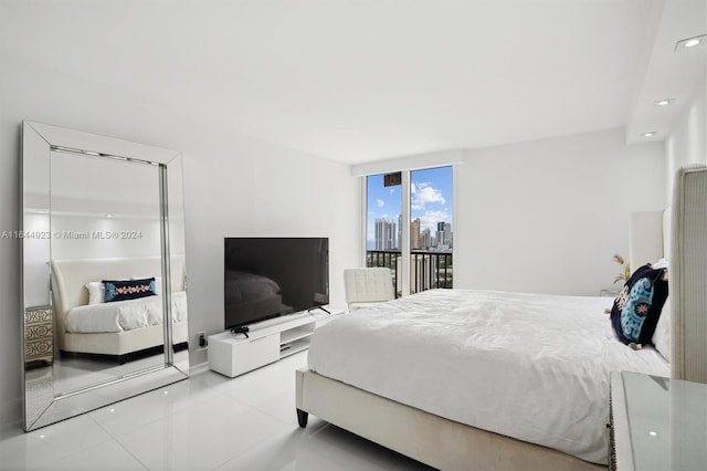 tiled bedroom featuring expansive windows and access to exterior