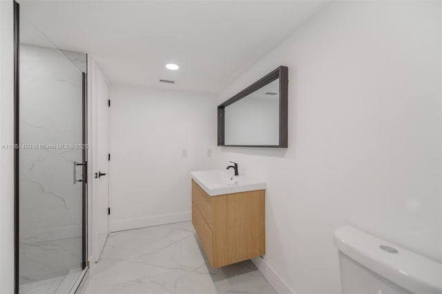 bathroom with vanity, toilet, and an enclosed shower