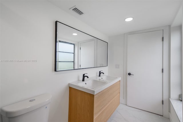 bathroom with toilet and vanity