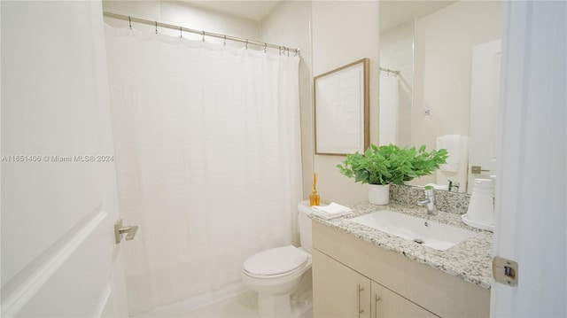 bathroom with vanity, toilet, and curtained shower