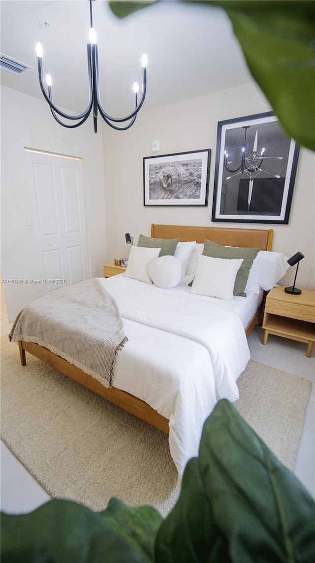 bedroom featuring a closet and a chandelier