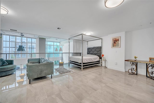 bedroom featuring floor to ceiling windows