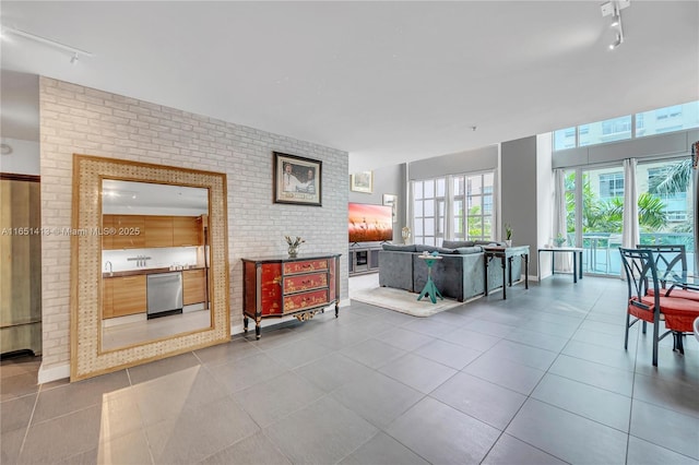 tiled living room with track lighting and brick wall