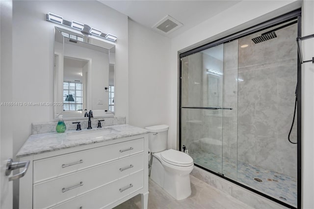 bathroom with vanity, toilet, and walk in shower