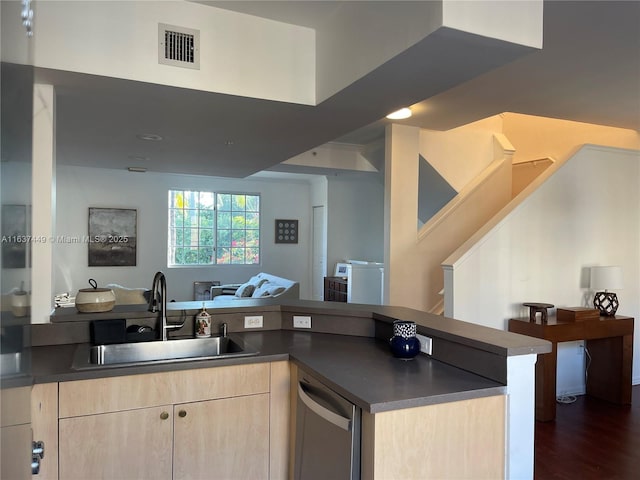 kitchen featuring light brown cabinetry, dishwasher, sink, kitchen peninsula, and dark wood-type flooring