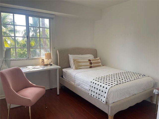 bedroom with dark hardwood / wood-style floors