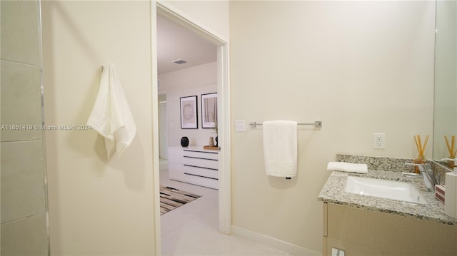 bathroom with tile patterned flooring and vanity