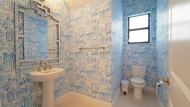 bathroom with tile patterned flooring, toilet, and sink