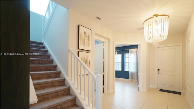 interior space featuring an inviting chandelier and tile patterned floors