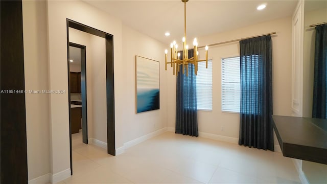 unfurnished dining area featuring an inviting chandelier and light tile patterned floors