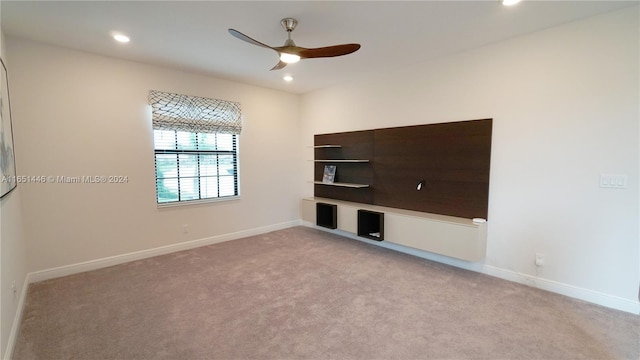 spare room featuring ceiling fan and light carpet