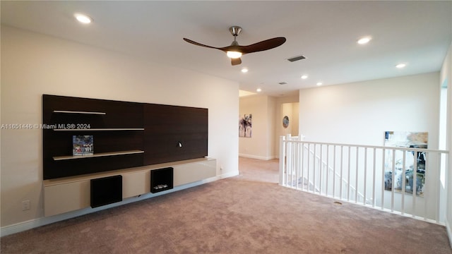 unfurnished living room with ceiling fan and carpet floors