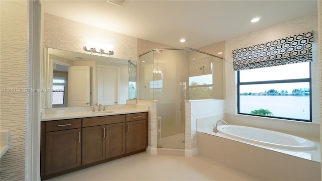 bathroom with tile patterned flooring, shower with separate bathtub, and vanity