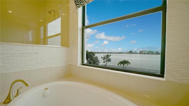 bathroom with a water view and a bathing tub