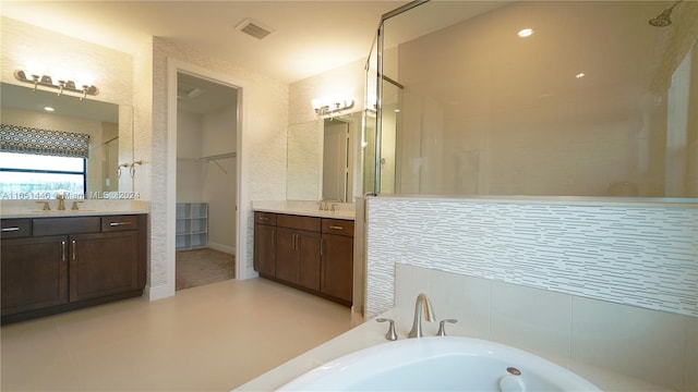 bathroom with vanity, independent shower and bath, and tile patterned floors