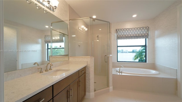 bathroom with vanity, tile patterned floors, and shower with separate bathtub