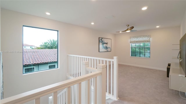 hallway featuring light carpet