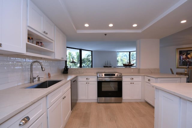 kitchen featuring black dishwasher, light hardwood / wood-style flooring, stainless steel electric range, sink, and light stone counters