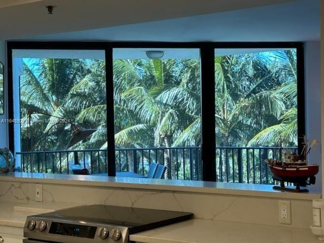 interior space featuring stainless steel electric stove and light countertops