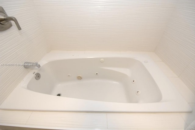 full bathroom featuring a whirlpool tub