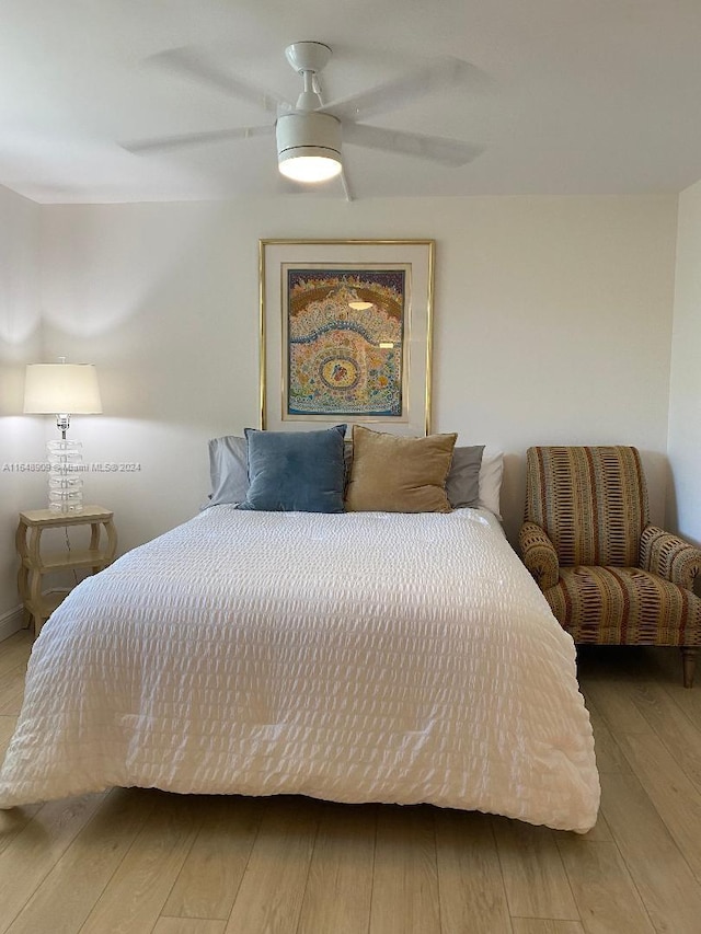 bedroom featuring a ceiling fan and wood finished floors