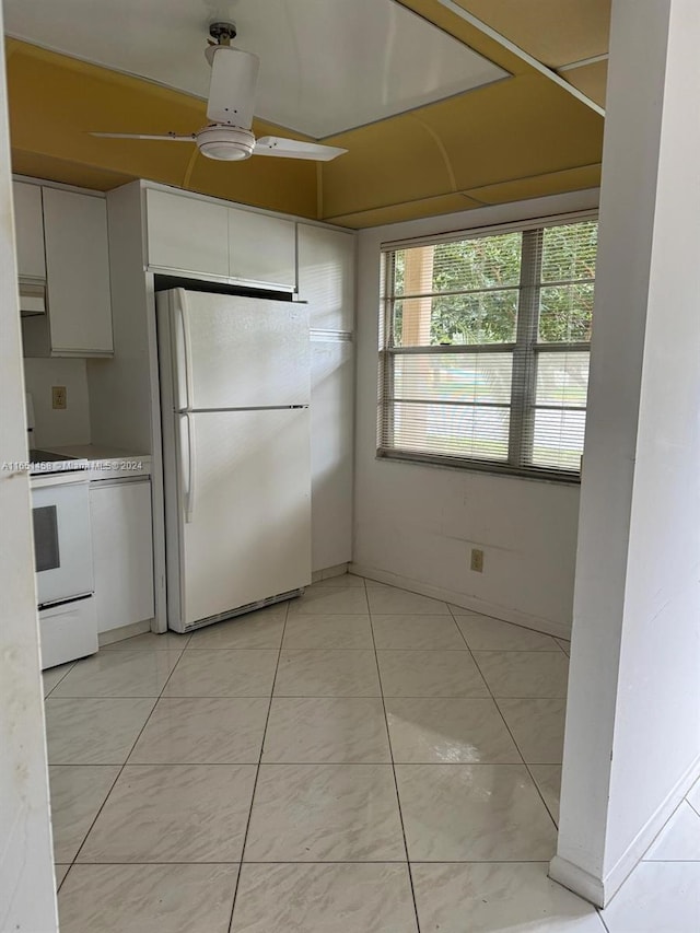 kitchen featuring white appliances, white cabinetry, and ceiling fan