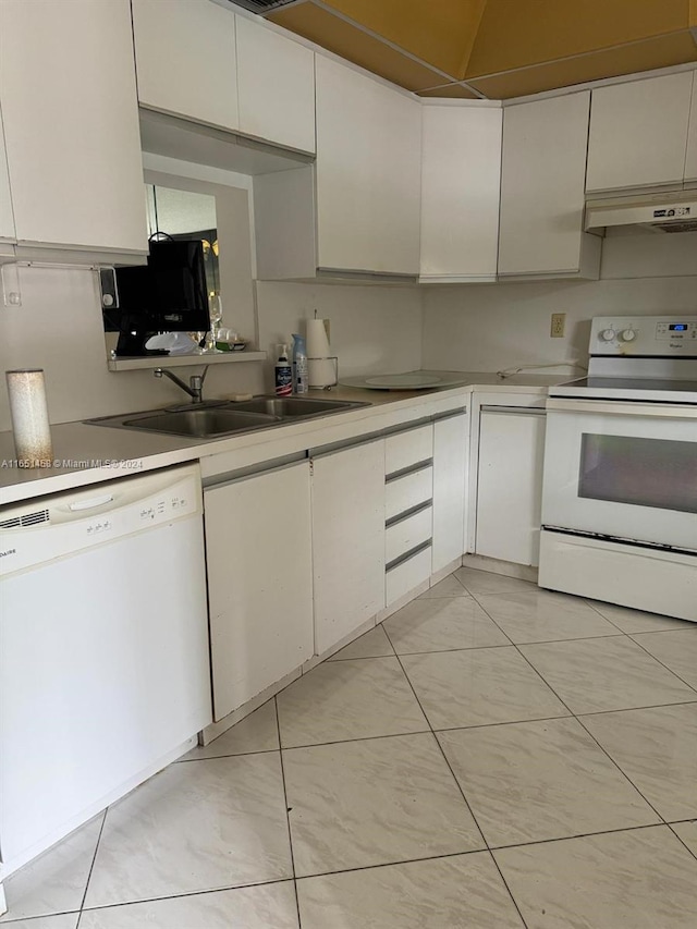 kitchen with sink, light tile patterned floors, white appliances, and white cabinetry