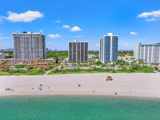 aerial view with a water view and a beach view