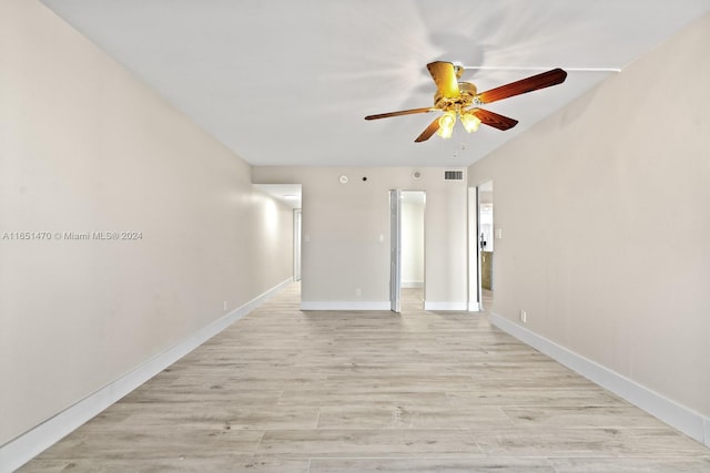 empty room featuring ceiling fan and light wood-type flooring