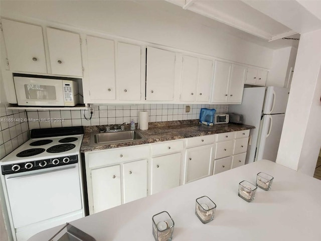 kitchen featuring sink, white appliances, white cabinets, and tasteful backsplash