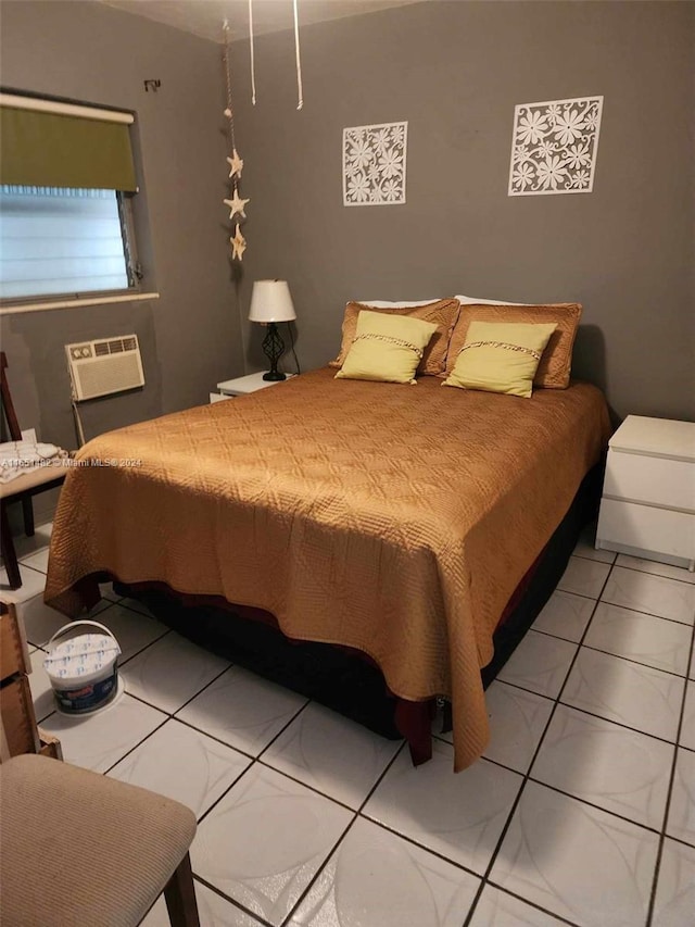 bedroom with a wall mounted air conditioner and light tile patterned flooring