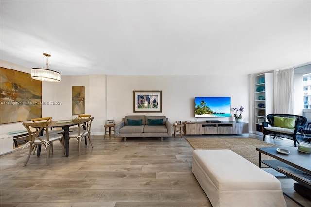 living room with hardwood / wood-style floors and an inviting chandelier