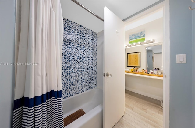 bathroom featuring hardwood / wood-style floors, shower / tub combo, and vanity