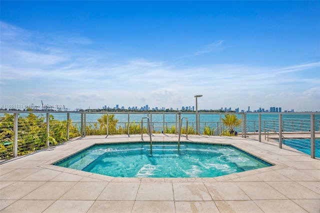 view of swimming pool featuring a water view