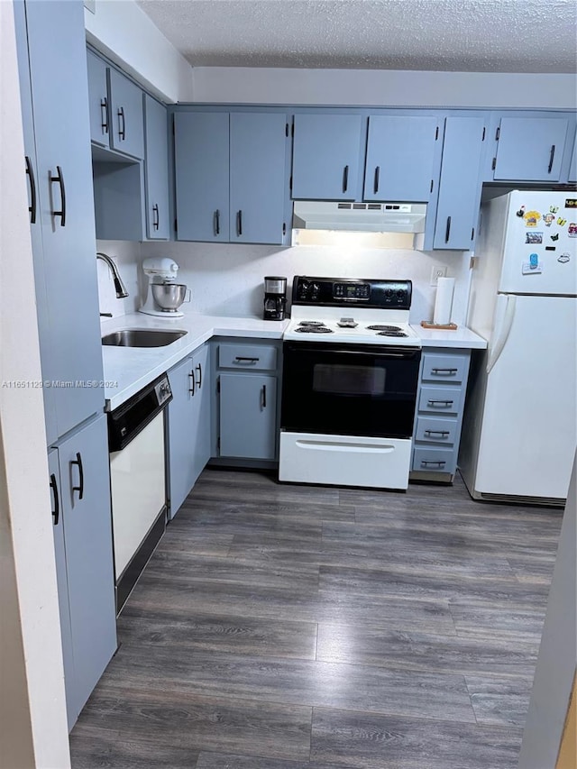 kitchen with dark hardwood / wood-style floors, white appliances, sink, and a textured ceiling