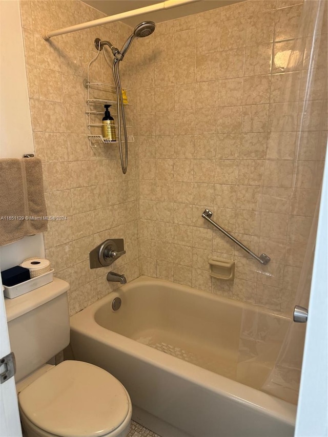 bathroom with toilet and tiled shower / bath combo