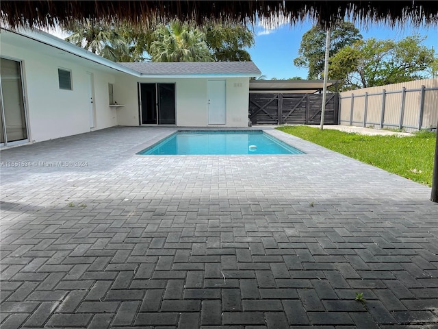 view of pool with a fenced in pool, fence, and a patio