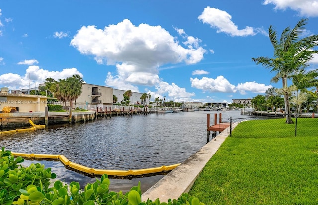 view of dock featuring a water view and a yard