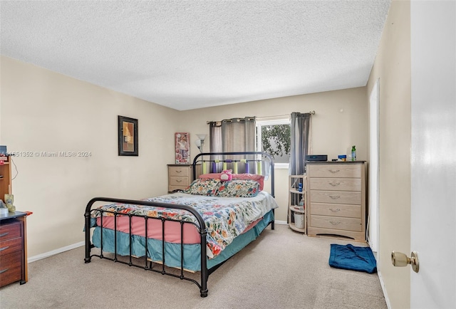 carpeted bedroom featuring a textured ceiling