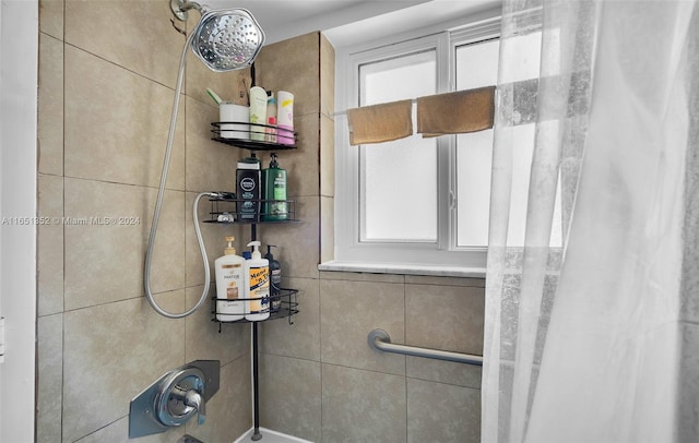 bathroom featuring shower / tub combo with curtain and a healthy amount of sunlight