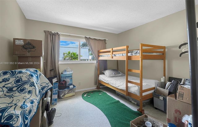 bedroom featuring carpet and a textured ceiling