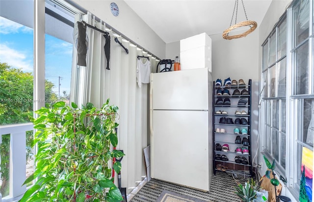 kitchen featuring white refrigerator and carpet floors